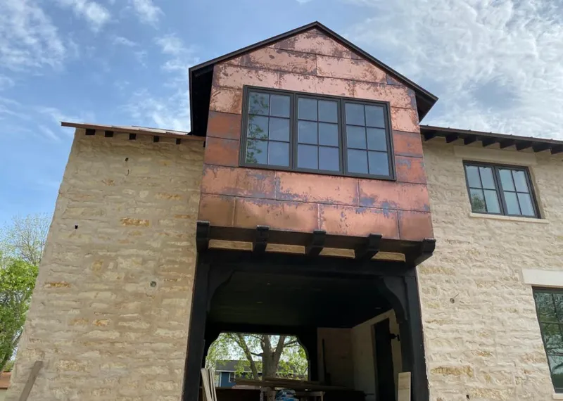 Copper metal panel facade on a stone building for Skylight Installation in Walden